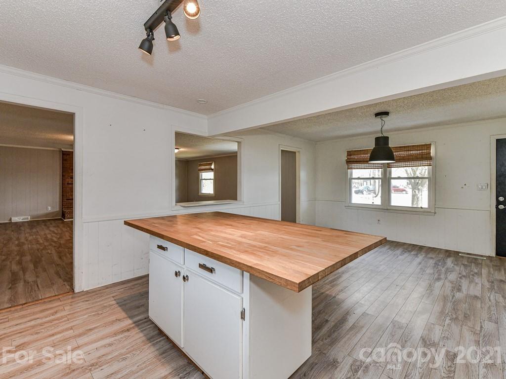 515 Sikes Mill Road Monroe, NC 28110 - Photo 14 of 33 a hall with kitchen island a stove and a window