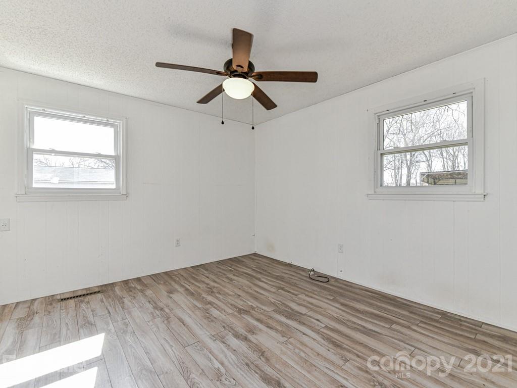 515 Sikes Mill Road Monroe, NC 28110 - Photo 19 of 33 a view of empty room with wooden floor and fan