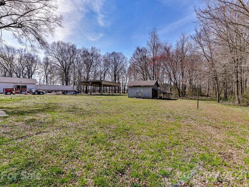 515 Sikes Mill Road Monroe, NC 28110 - Photo 30 of 33 a view of a yard with a house in the background