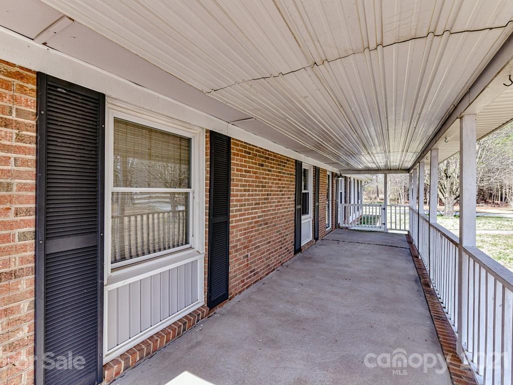 515 Sikes Mill Road Monroe, NC 28110 - Photo 4 of 33 a view of a porch with wooden floor and iron stairs