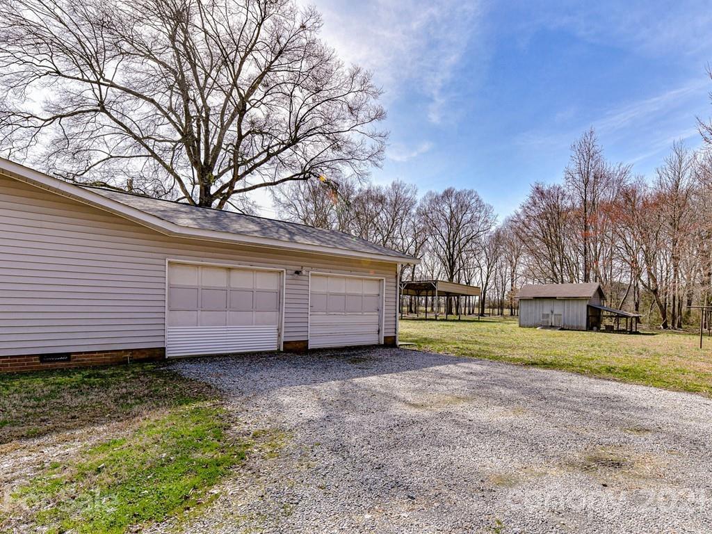 515 Sikes Mill Road Monroe, NC 28110 - Photo 32 of 33 a view of a backyard with large trees