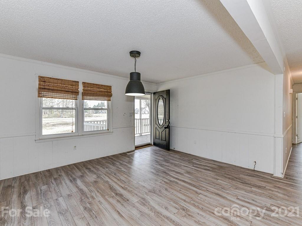 515 Sikes Mill Road Monroe, NC 28110 - Photo 7 of 33 a view of an empty room with a window and wooden floor