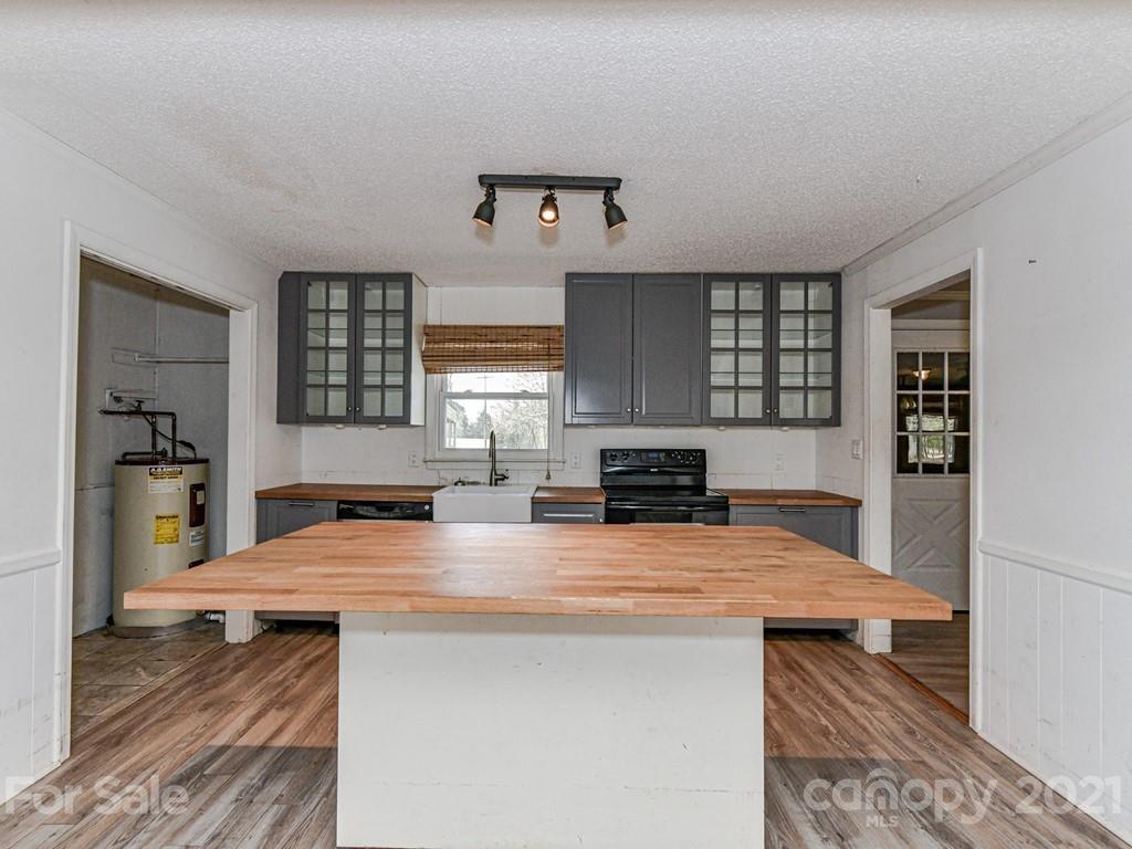 515 Sikes Mill Road Monroe, NC 28110 - Photo 9 of 33 a kitchen with a stove a sink and a refrigerator