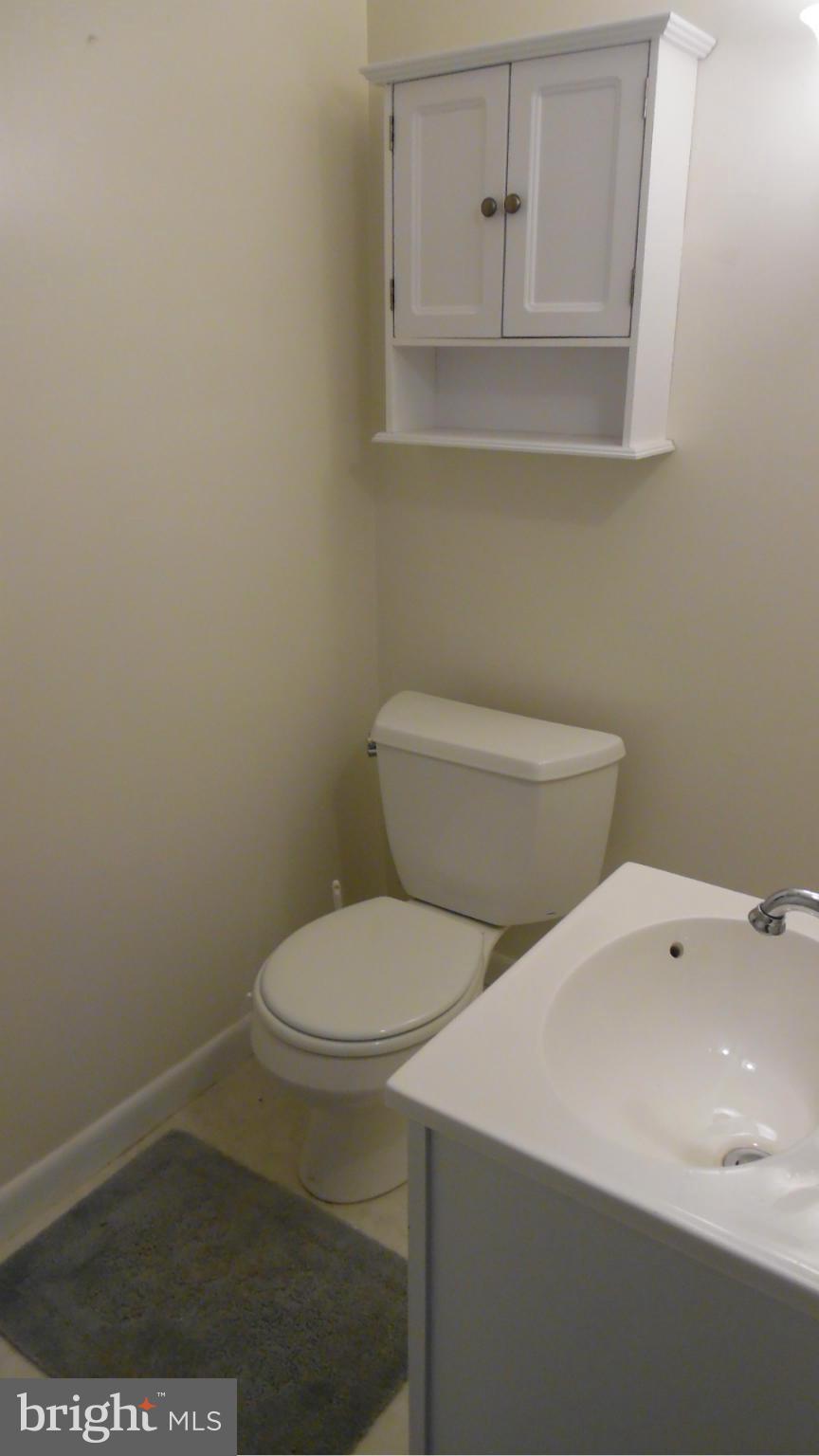 17913 Marshall Mill Road Hampstead, MD 21074 - Photo 3 of 16 a white toilet sitting next to a bathroom sink