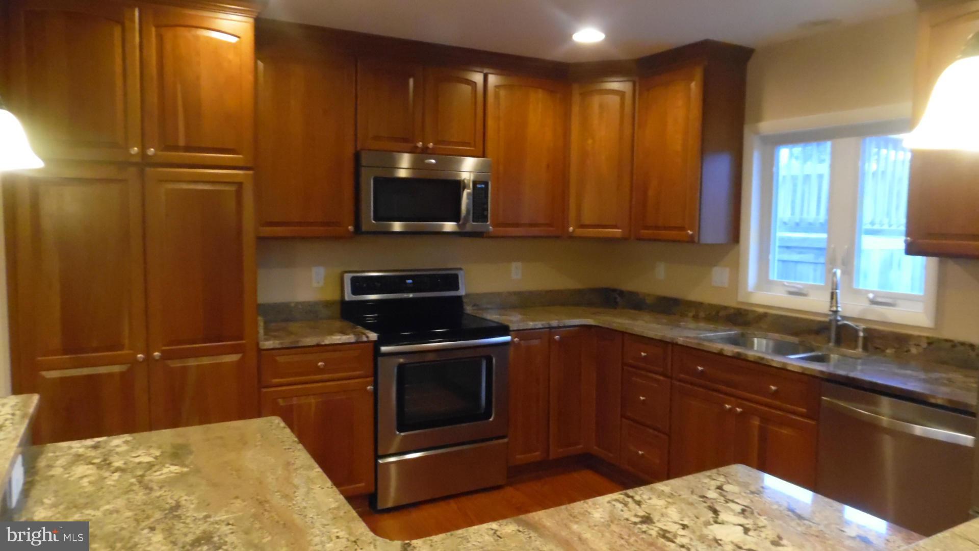 17913 Marshall Mill Road Hampstead, MD 21074 - Photo 8 of 16 a kitchen with a sink stove and microwave