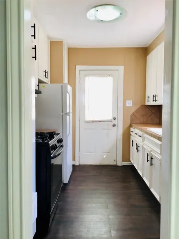 a kitchen with cabinets and a stove