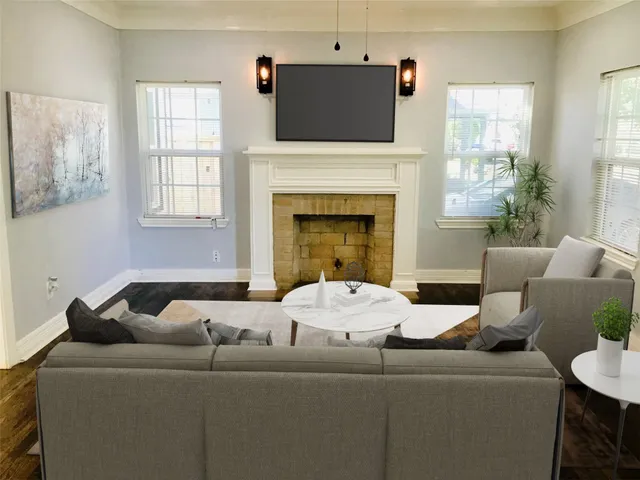 a living room with furniture and a fireplace