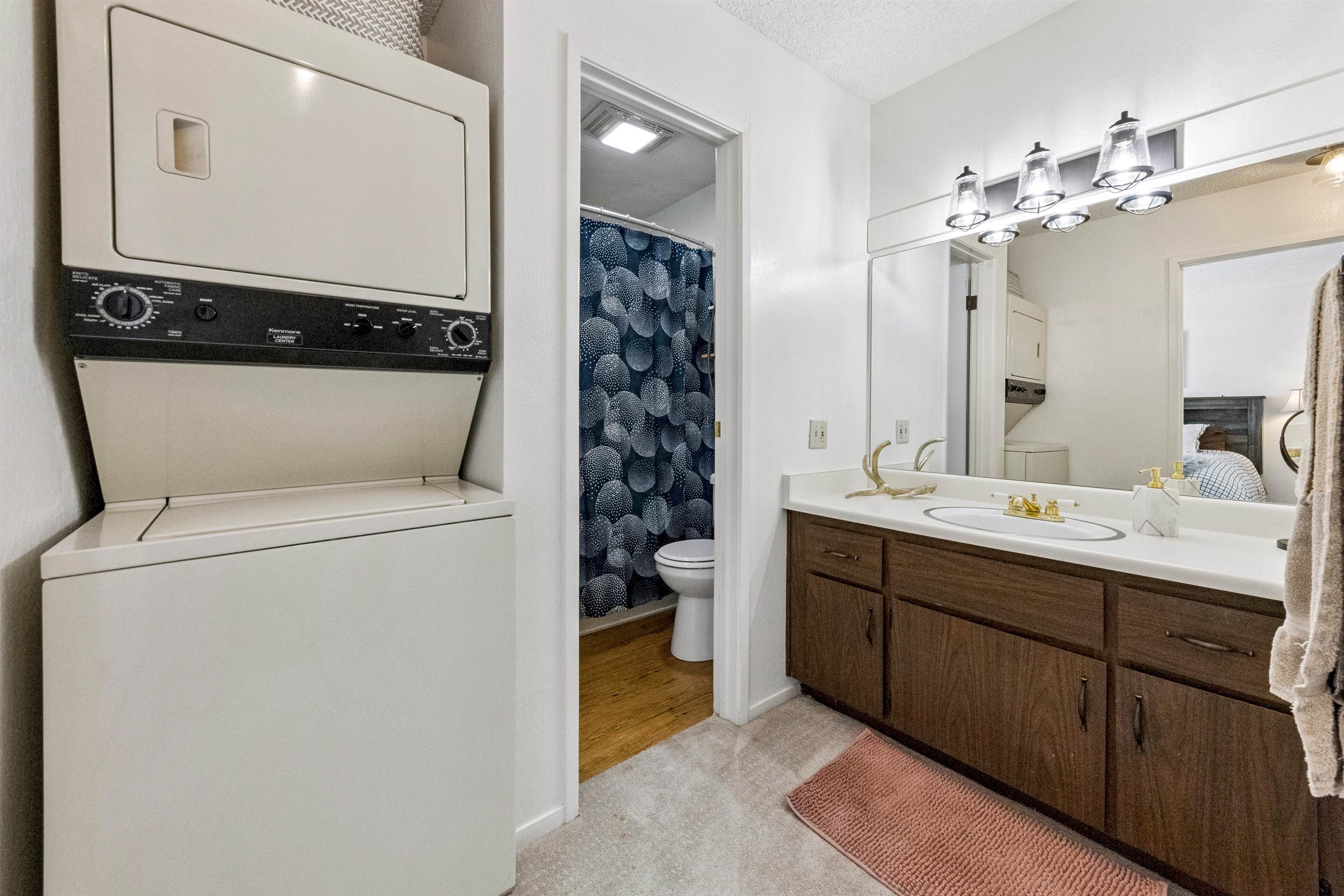 11727 Snowpeak Way, Unit 574 Truckee, CA 96161 - Photo 8 of 15 a bathroom with a toilet sink and mirror