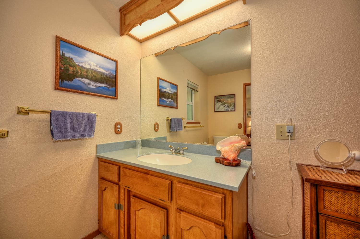 23998 Stable Road Sonora, CA 95370 - Photo 17 of 41 a bathroom with a sink mirror vanity and toilet