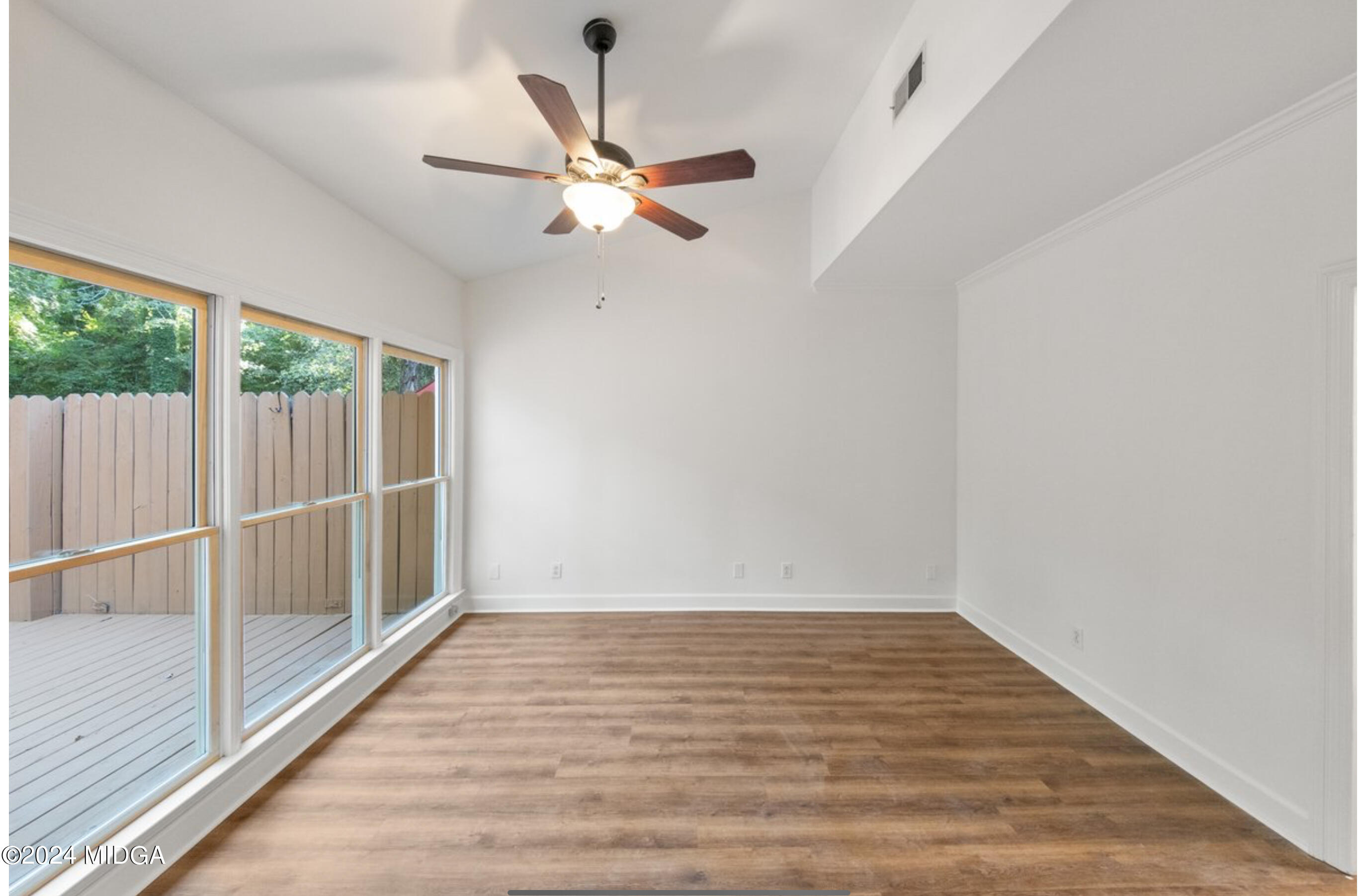 154 Lokchapee Landing Macon, GA 31210 - Photo 14 of 29 an empty room with wooden floor fan and windows