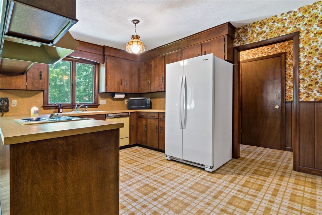 26 Danforth Street Rehoboth, MA 02769 - Photo 13 of 30 a kitchen with stainless steel appliances a refrigerator sink and cabinets