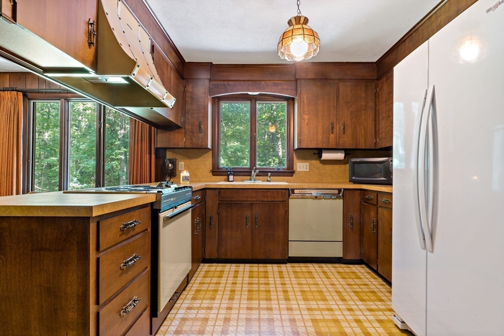 26 Danforth Street Rehoboth, MA 02769 - Photo 10 of 30 a kitchen with a sink window and cabinets