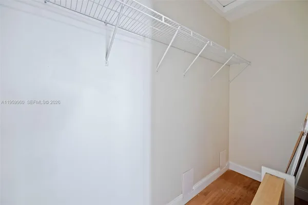 a view of walk in closet with empty racks