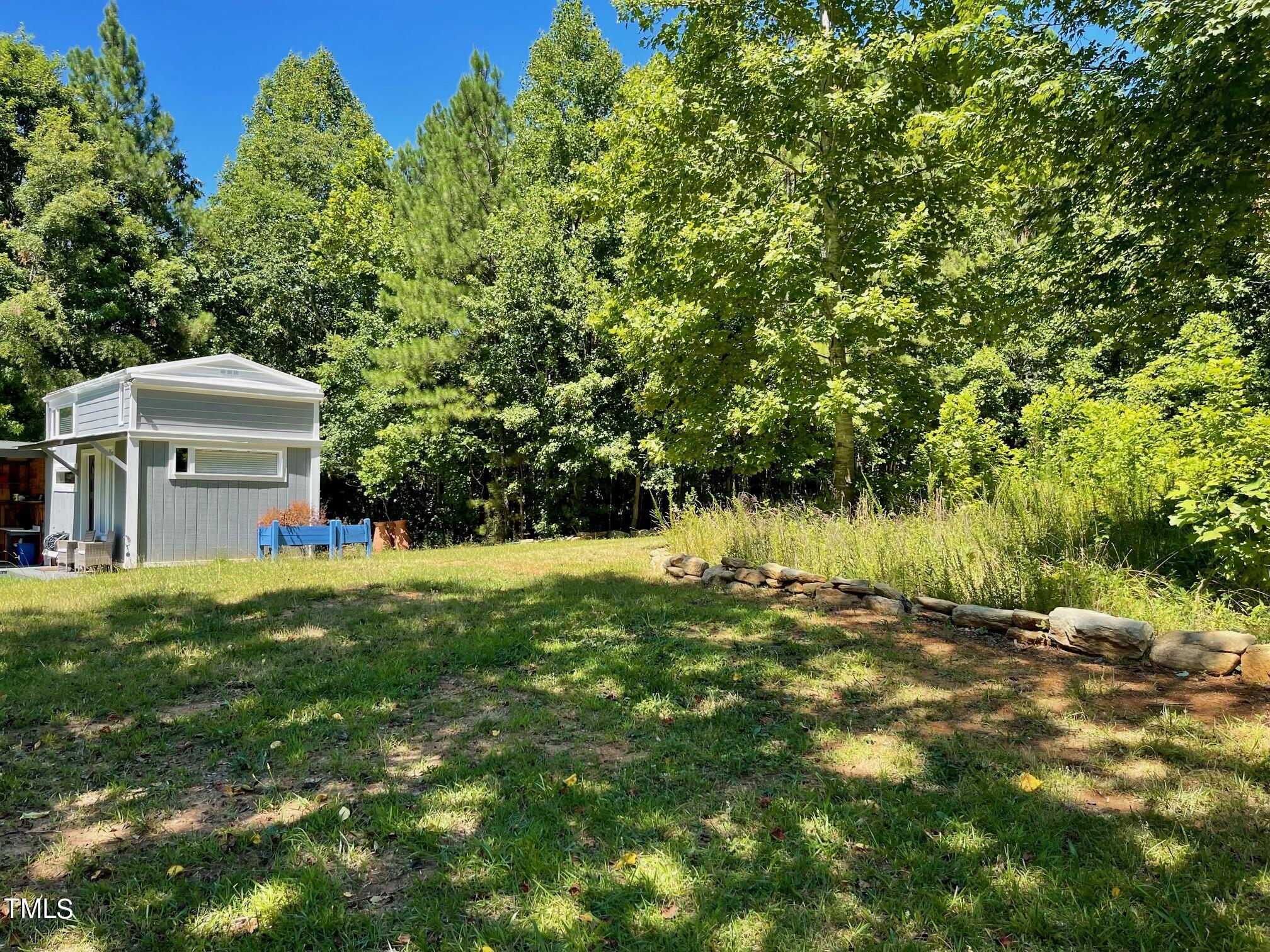 3081 Jacksontown Road Manson, NC 27553 - Photo 5 of 39 a backyard of a house with trees and wooden fence