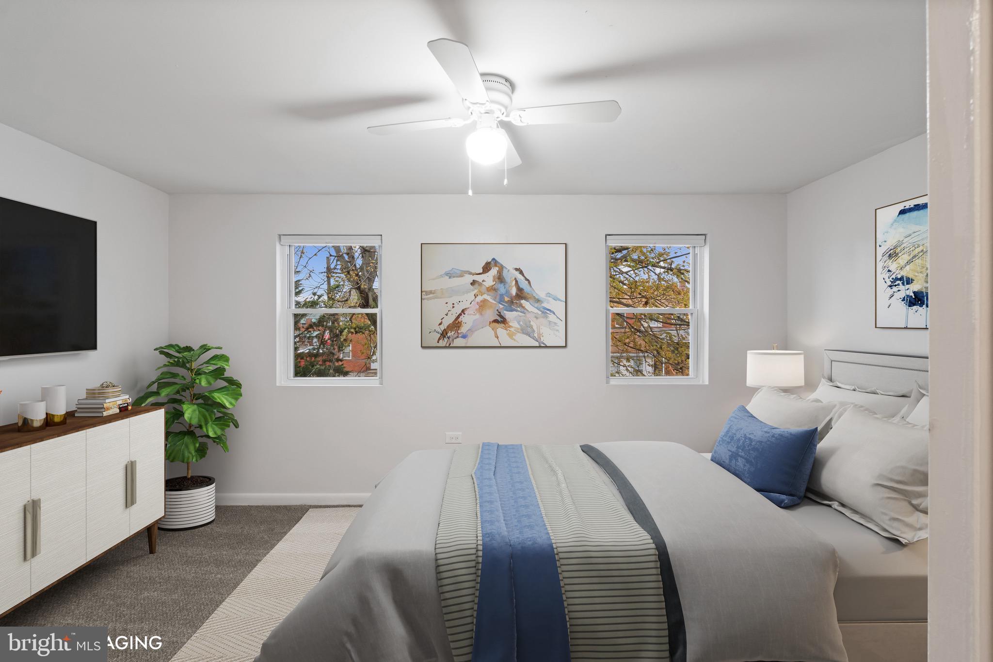 8146 Del Haven Road Baltimore, MD 21222 - Photo 13 of 35 a bedroom with a large bed and a chandelier