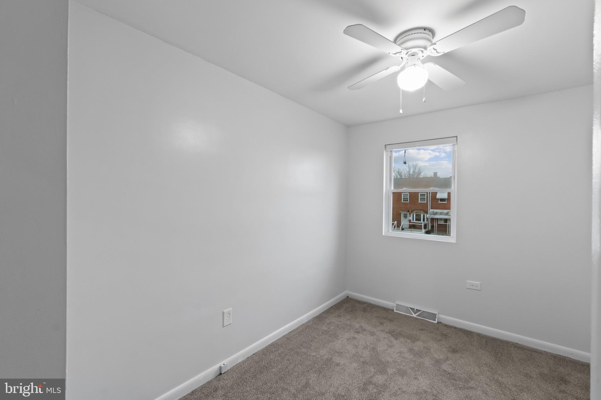 8146 Del Haven Road Baltimore, MD 21222 - Photo 16 of 35 an empty room with a window and a fan