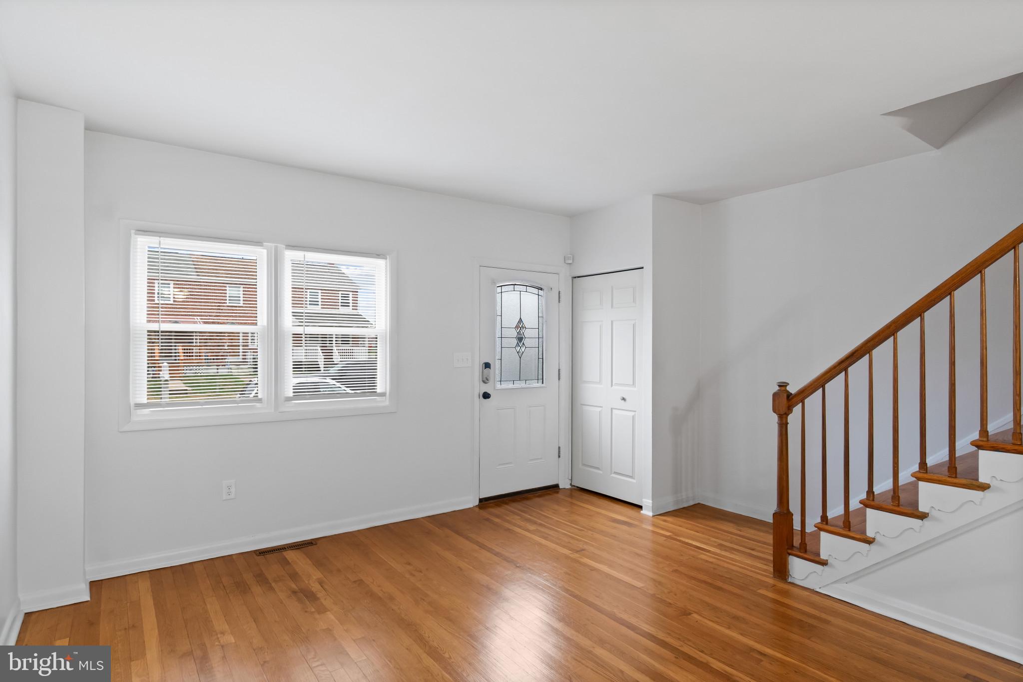 8146 Del Haven Road Baltimore, MD 21222 - Photo 3 of 35 an empty room with wooden floor and windows