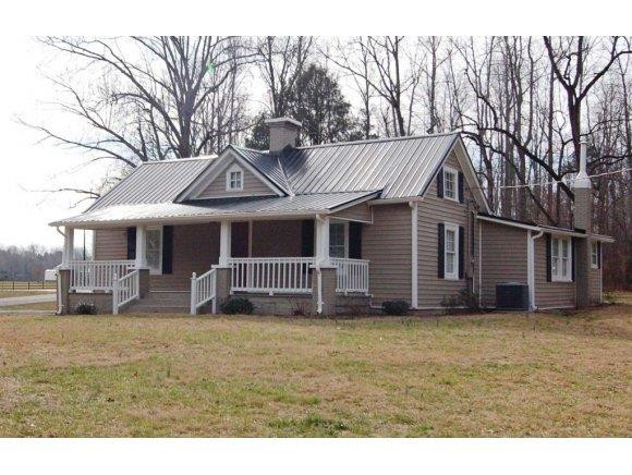 a front view of a house with a yard and fence