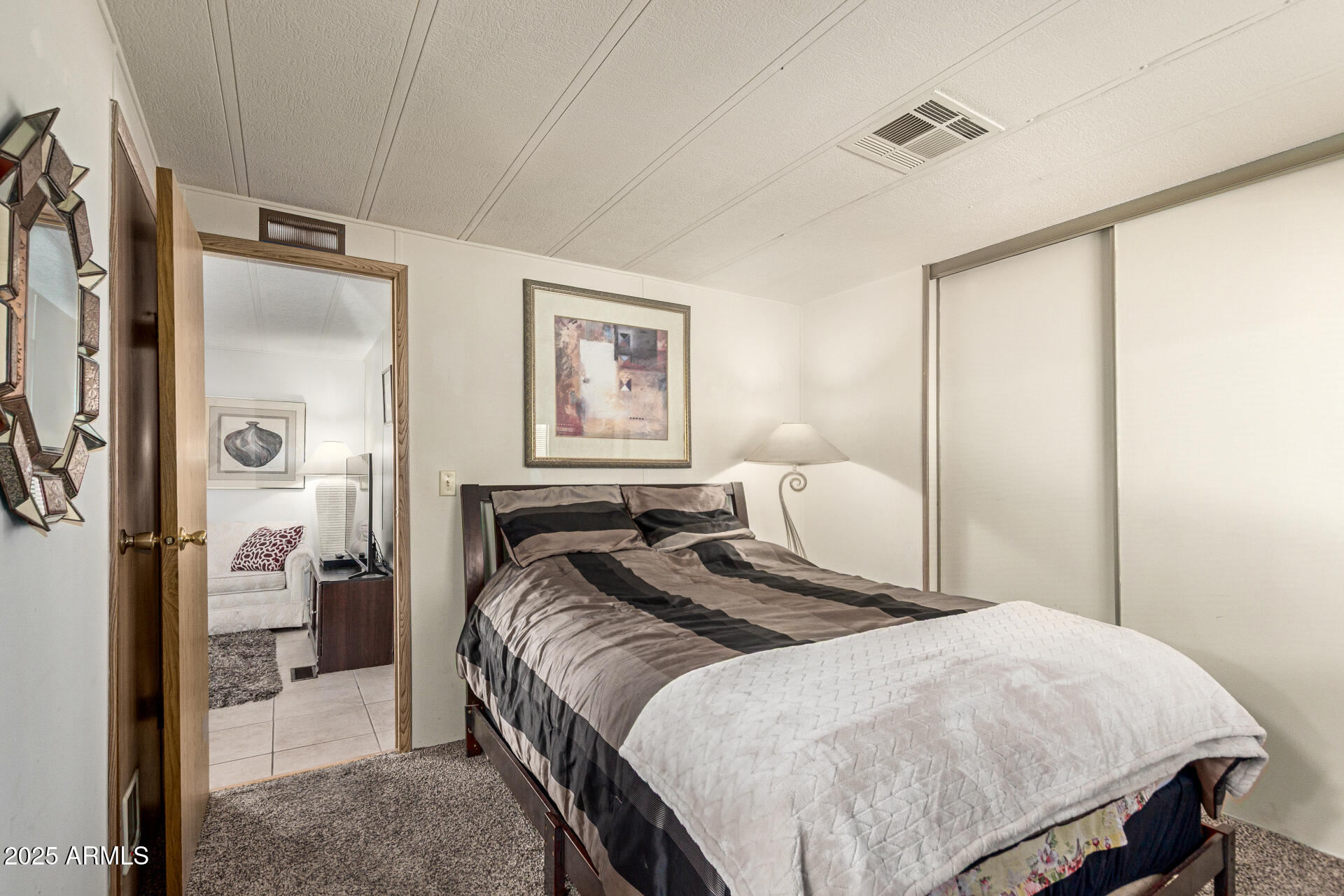 301 South Signal Butte Road, Unit 706 Apache Junction, AZ 85120 - Photo 29 of 51 a bedroom with a bed and a mirror