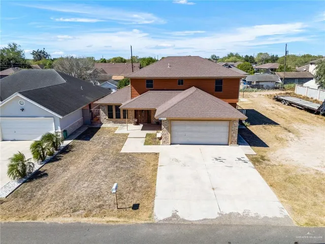 an aerial view of a house with a yard