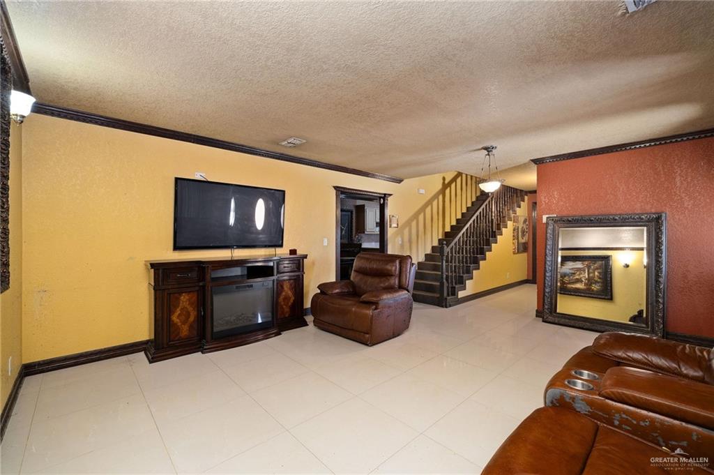 117 Hernandez Road Rio Grande City, TX 78582 - Photo 4 of 23 a living room with furniture and a flat screen tv