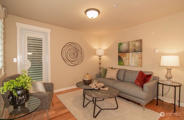 a living room with furniture and a lamp