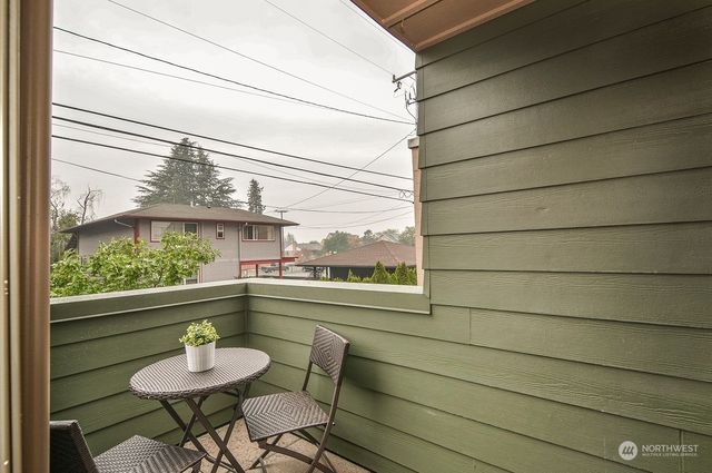 a view of a two chairs in the balcony