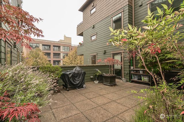 a view of a patio with table and chairs and potted plants