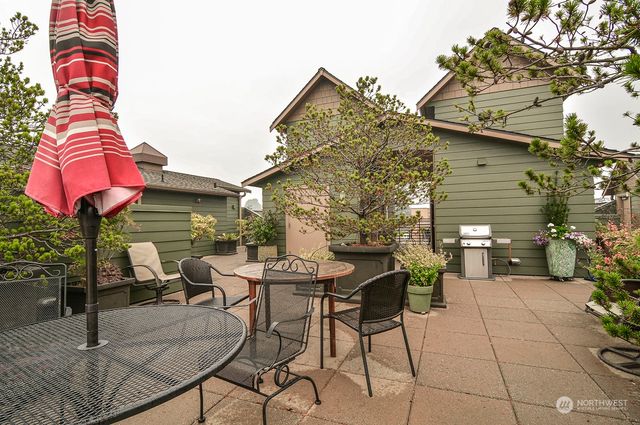 a backyard of a house with table and chairs