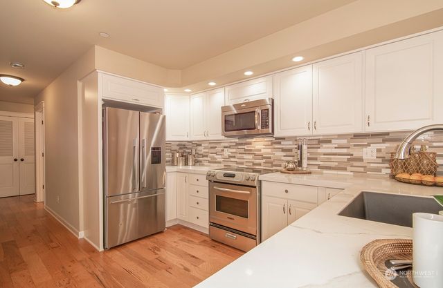 a kitchen with a sink cabinets and stainless steel appliances