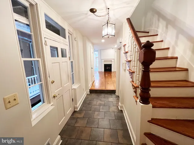 a view of entryway and hall with wooden floor