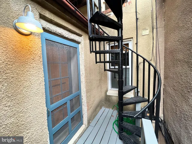 a view of staircase with wooden floor and chair