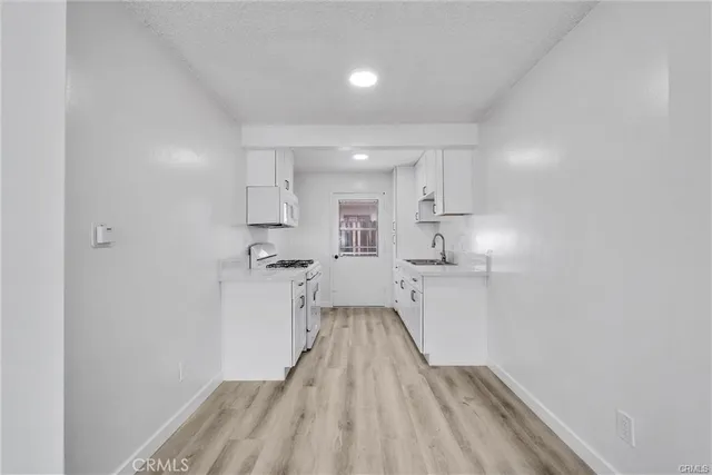 a view of a kitchen with wooden floor