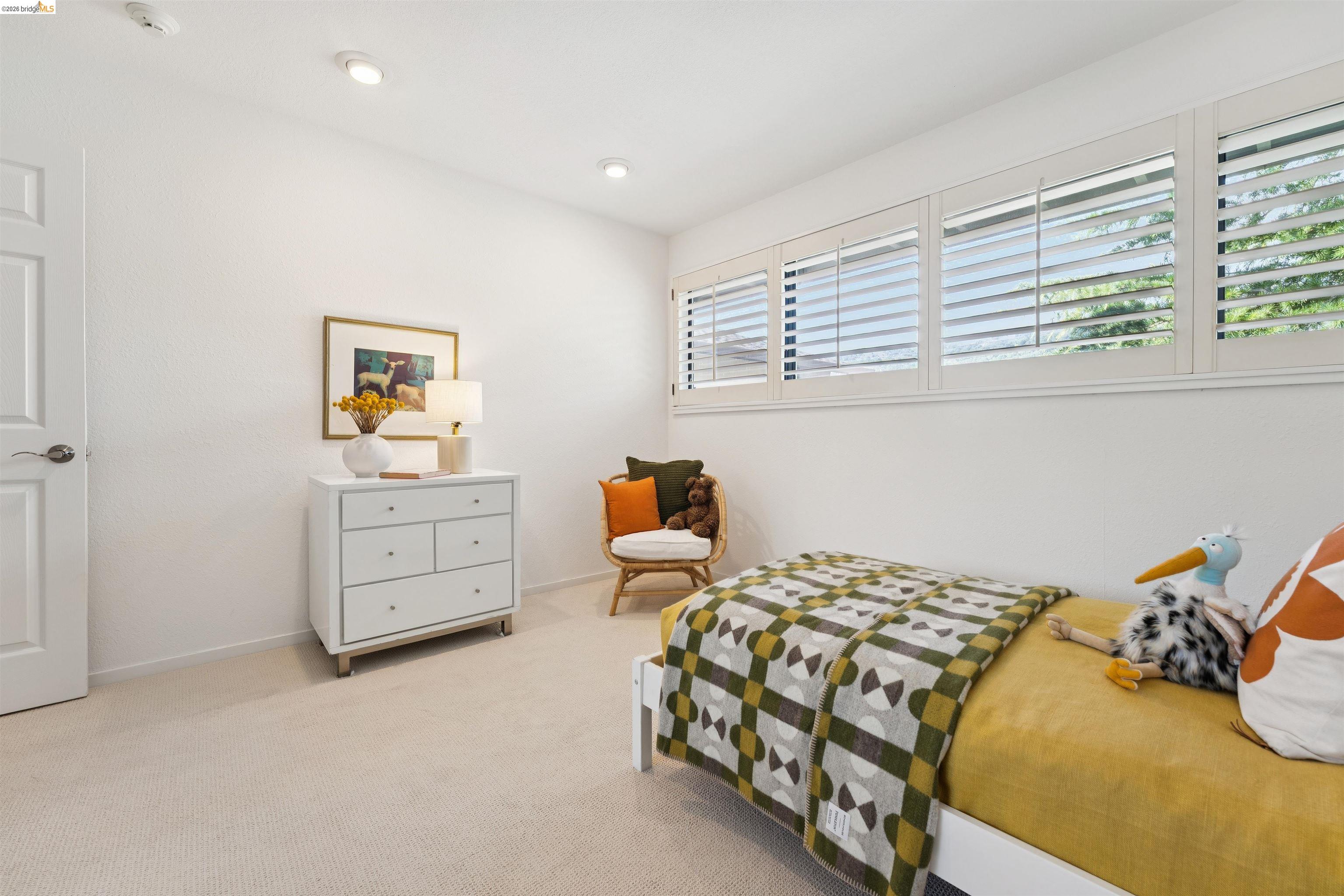 7 Jo Lin Court El Sobrante, CA 94803 - Photo 59 of 99 Light-filled room featuring white walls, recessed lighting, white plantation shutters, and neutral carpeting