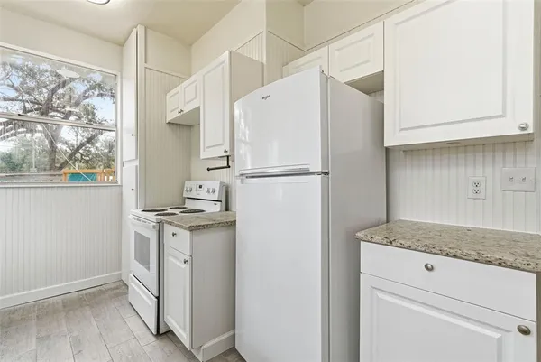 a white refrigerator freezer sitting inside of a kitchen
