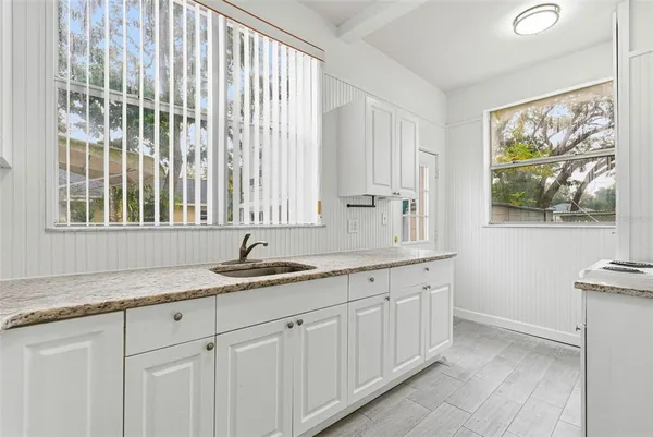 a kitchen with a sink and cabinets