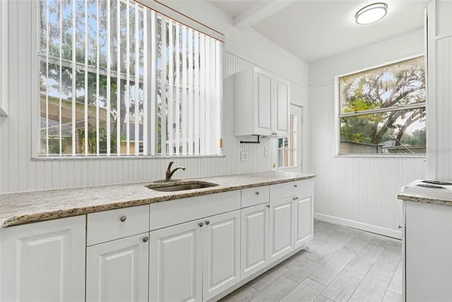 a kitchen with stainless steel appliances white cabinets and white appliances