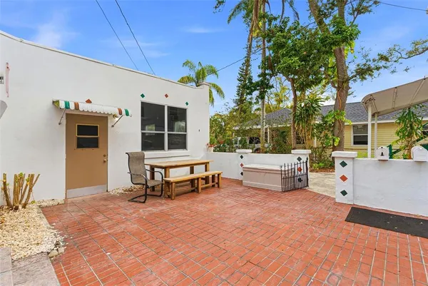 a balcony with furniture and a potted plant