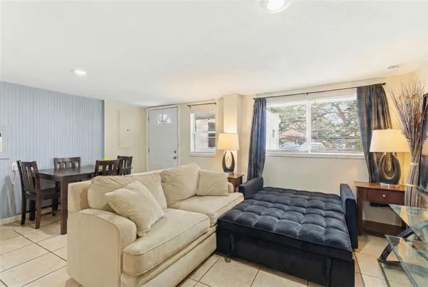 a living room with furniture window and a flat screen tv