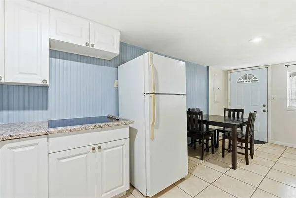 a kitchen with refrigerator cabinets and table