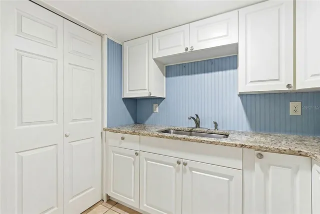 a bathroom with a shower sink and mirror