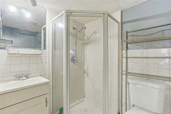 a bathroom with a shower sink and mirror