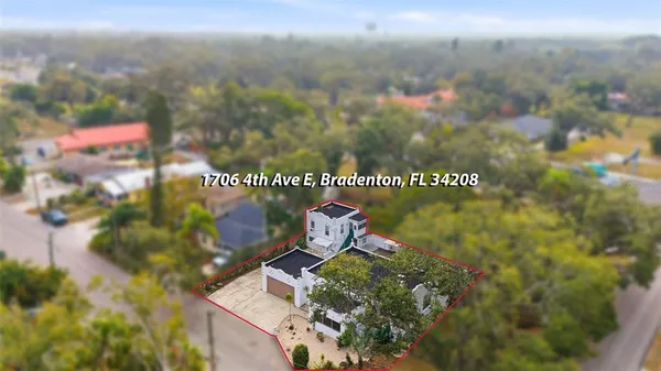 an aerial view of a house with a yard