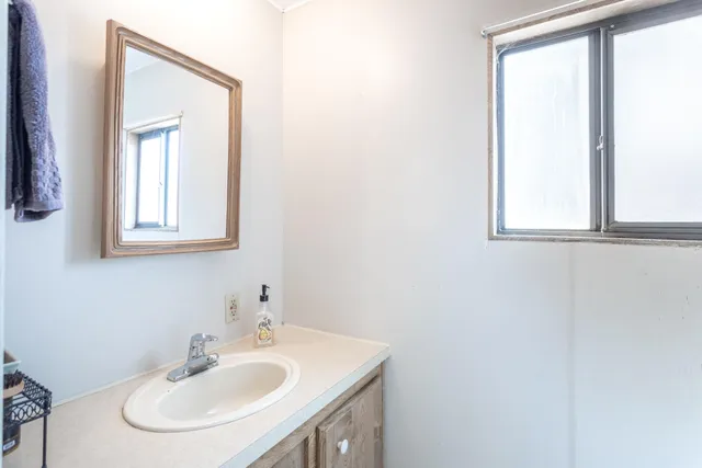 a bathroom with a sink and a mirror