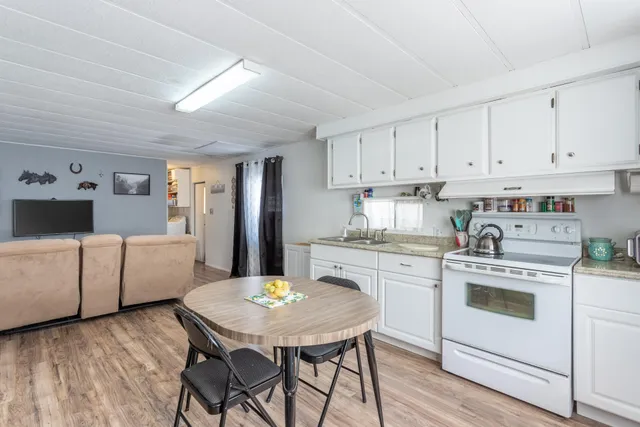a kitchen with a white cabinets and chairs