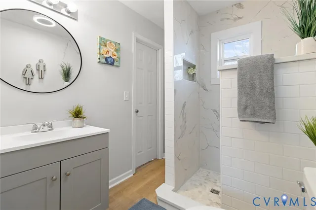 a bathroom with a sink mirror and vanity