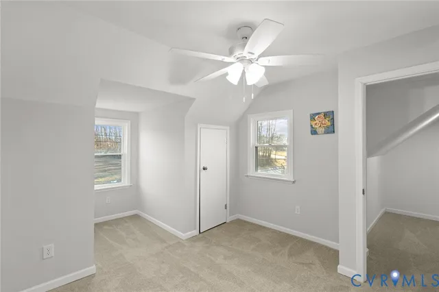 a view of an empty room with a ceiling fan