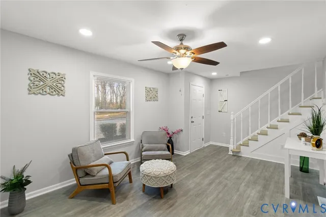 a living room with furniture and wooden floor