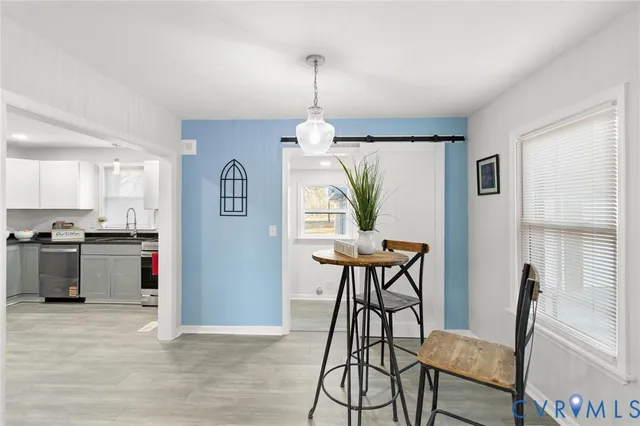 a view of a dining room with furniture window and wooden floor
