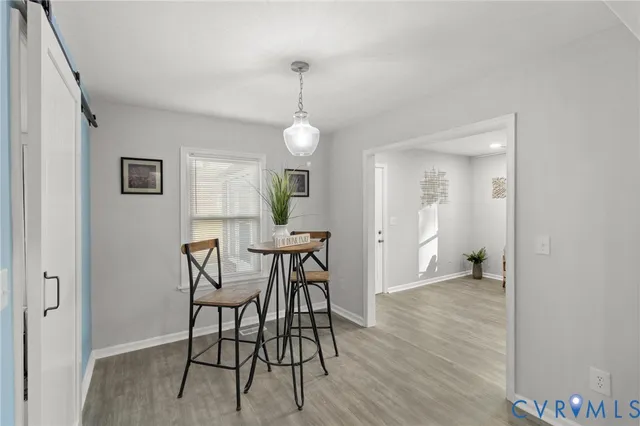 a view of a dining room with furniture and wooden floor